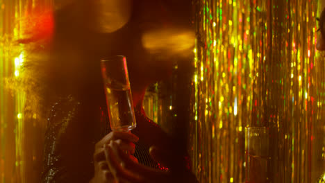 Close-Up-Of-Two-Women-Dancing-In-Nightclub-Bar-Or-Disco-Drinking-Alcohol-With-Sparkling-Lights-18